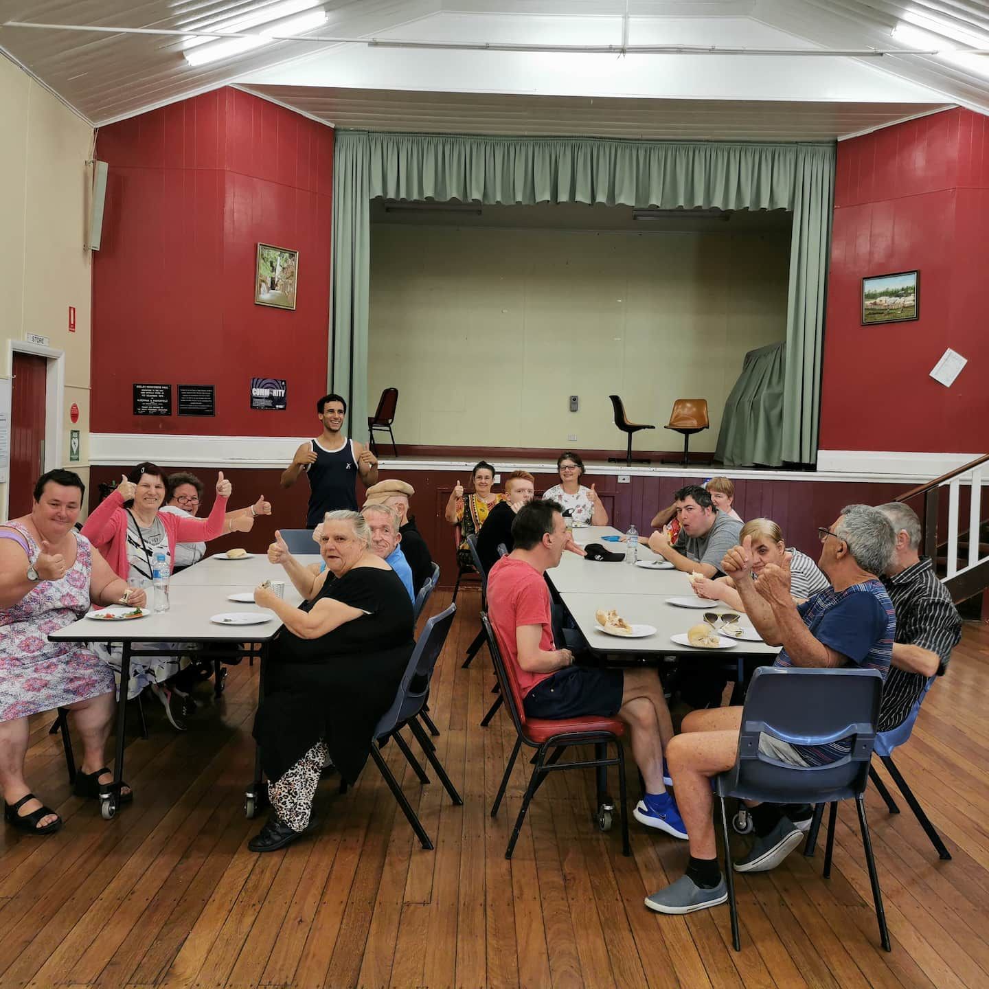 A Group of People Are Sitting Around Tables Laughing —True Form Fitness In Gwandalan, NSW