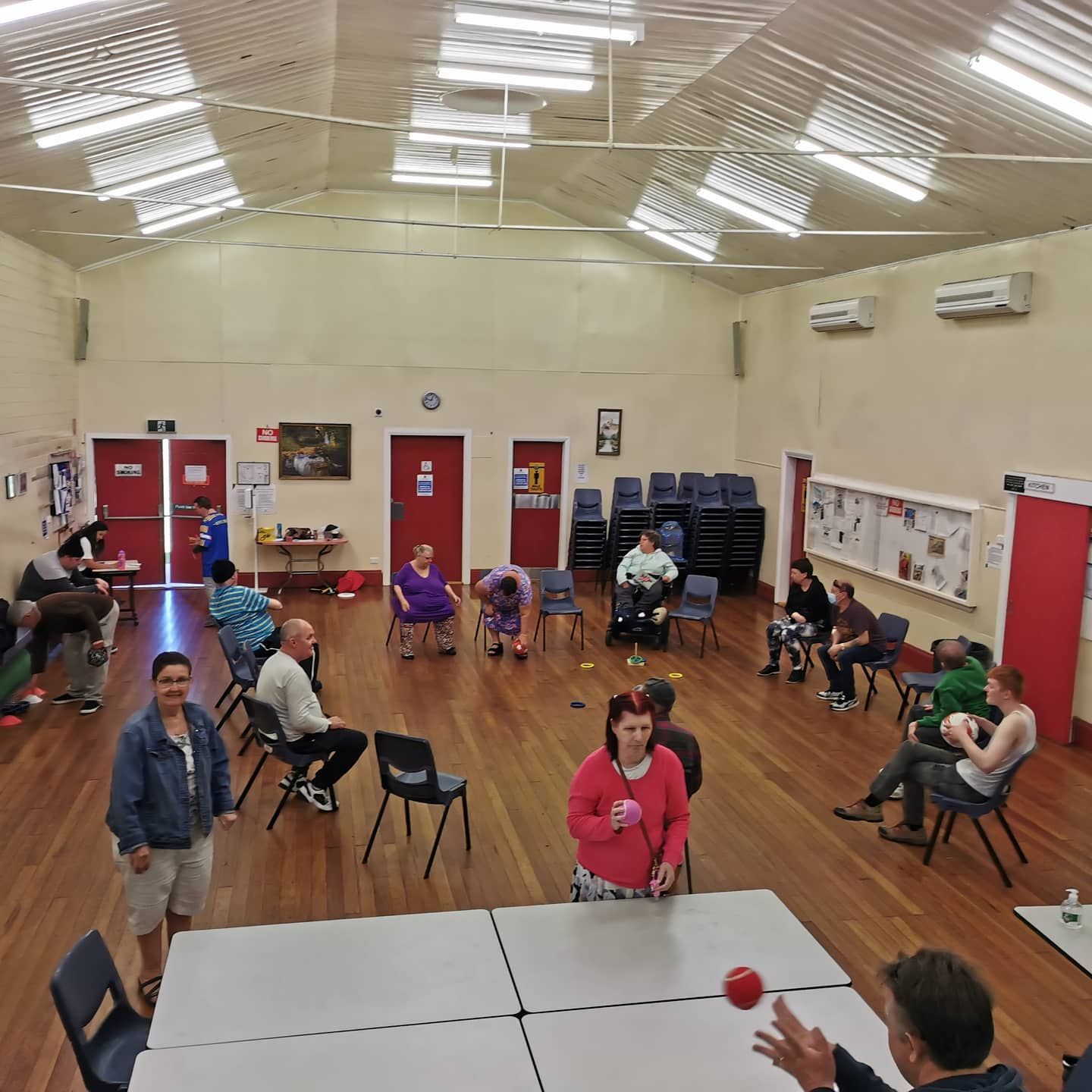A Group of People Are Doing Lunges With Medicine Balls in a Gym —True Form Fitness In Gwandalan, NSW