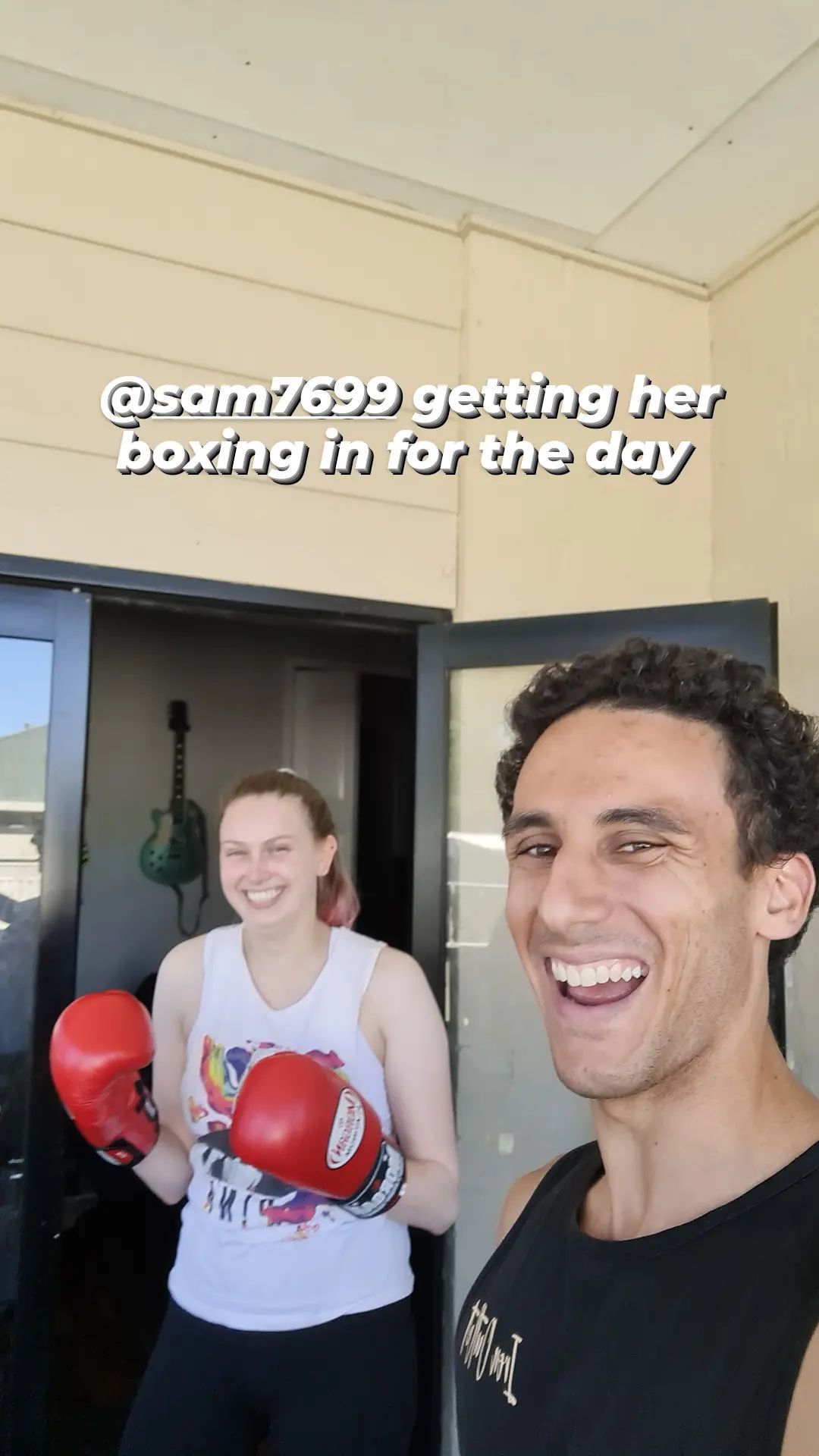 Man and woman smiling by doorway, woman wearing boxing gloves —True Form Fitness In Gwandalan, NSW