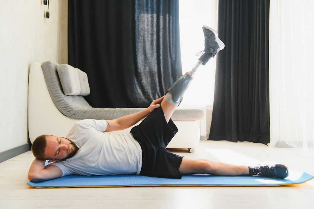 A Man With a Prosthetic Leg is Laying on a Yoga Mat —True Form Fitness In Gwandalan, NSW