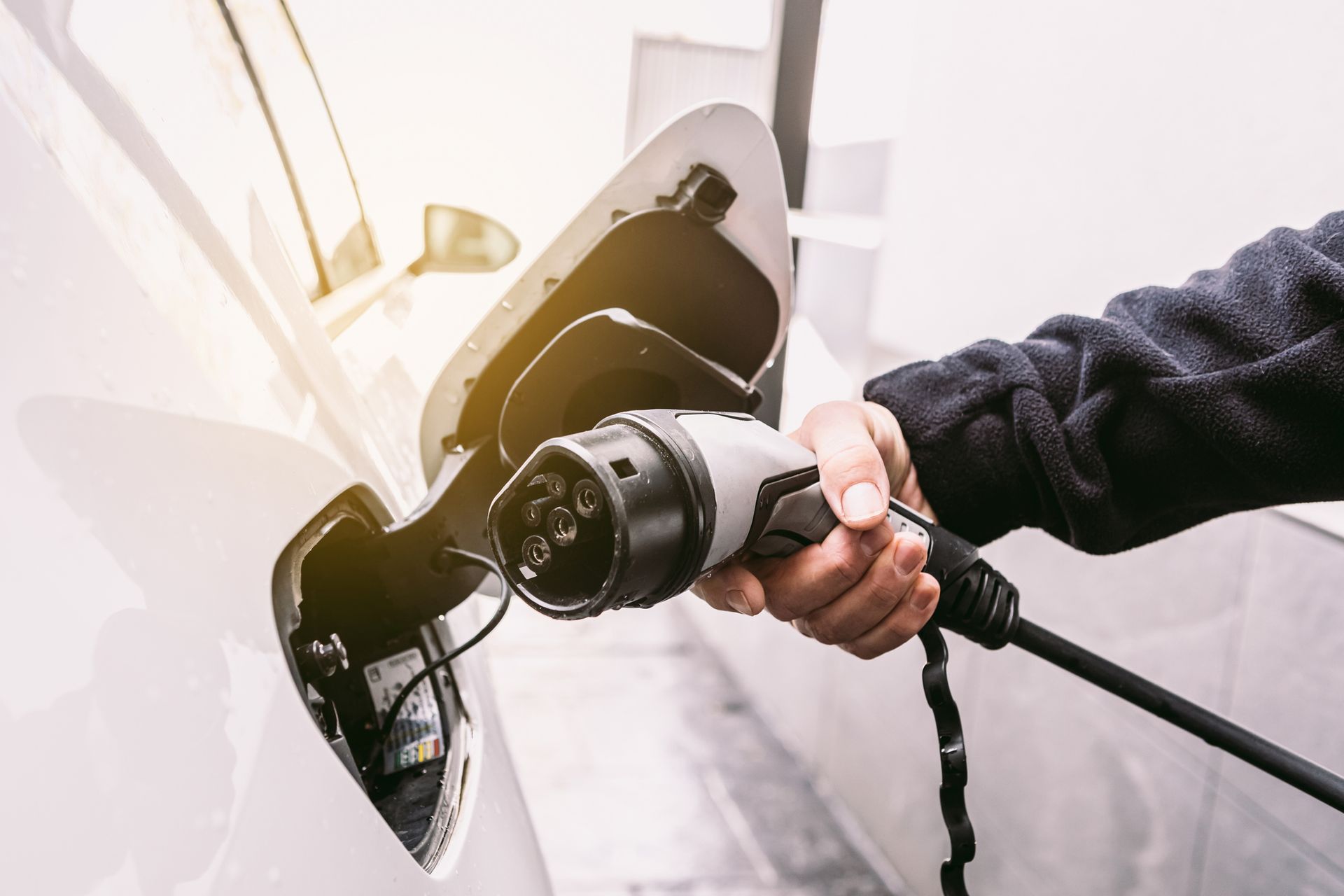 A person is charging an electric car with a charger.