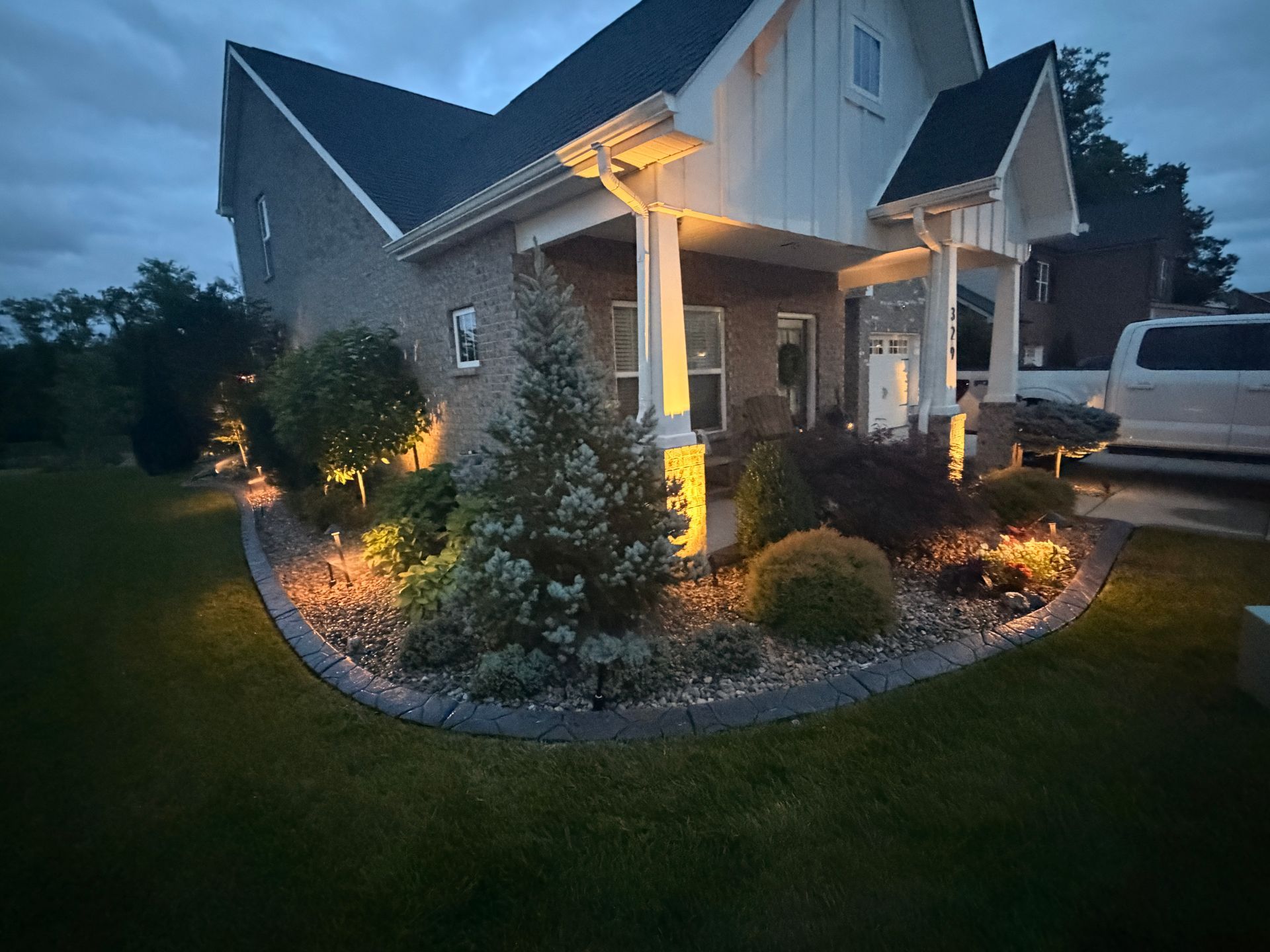 Home with landscaping and well maintained lawn