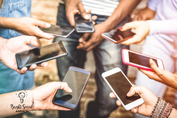 Hands holding and using smartphones. Close-up view of group, screens visible.