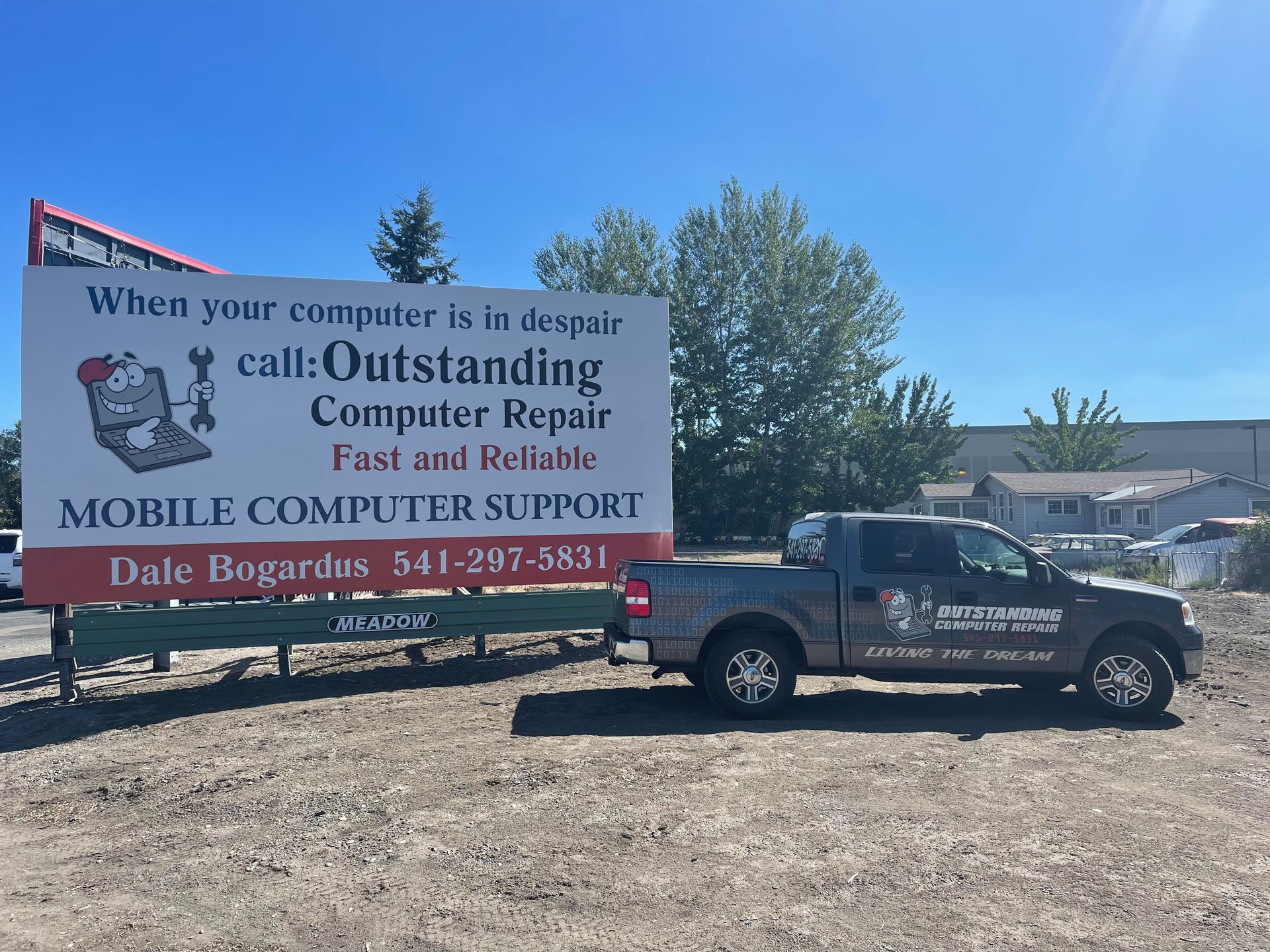 Truck and billboard for Dale Bogert’s mobile computer support in a sunny lot