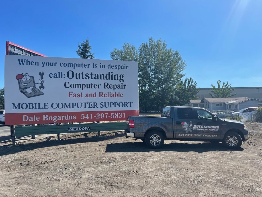 Truck and billboard for Dale Bogert’s mobile computer support in a sunny lot