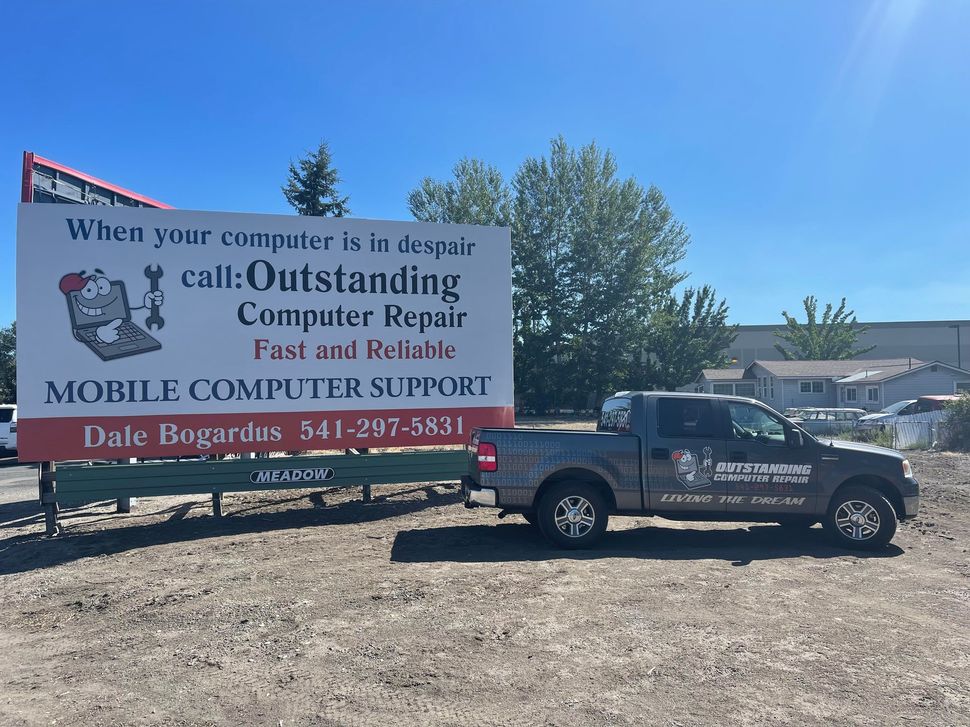 Truck and billboard for Dale Bogert’s mobile computer support in a sunny lot