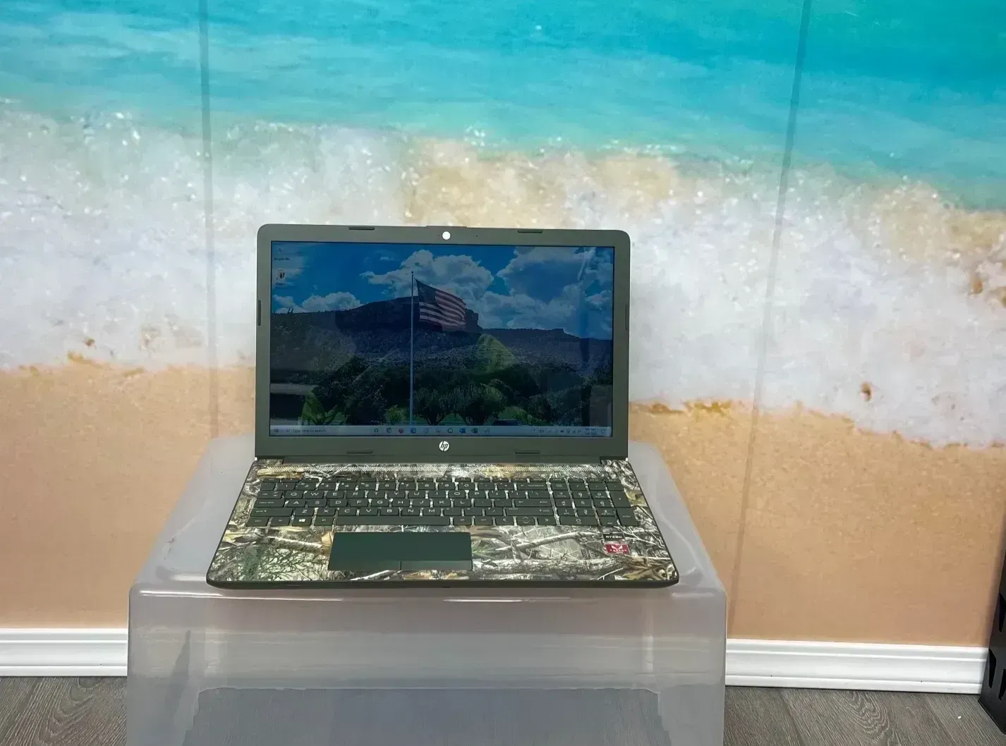 Laptop on a clear stand against a beach mural background