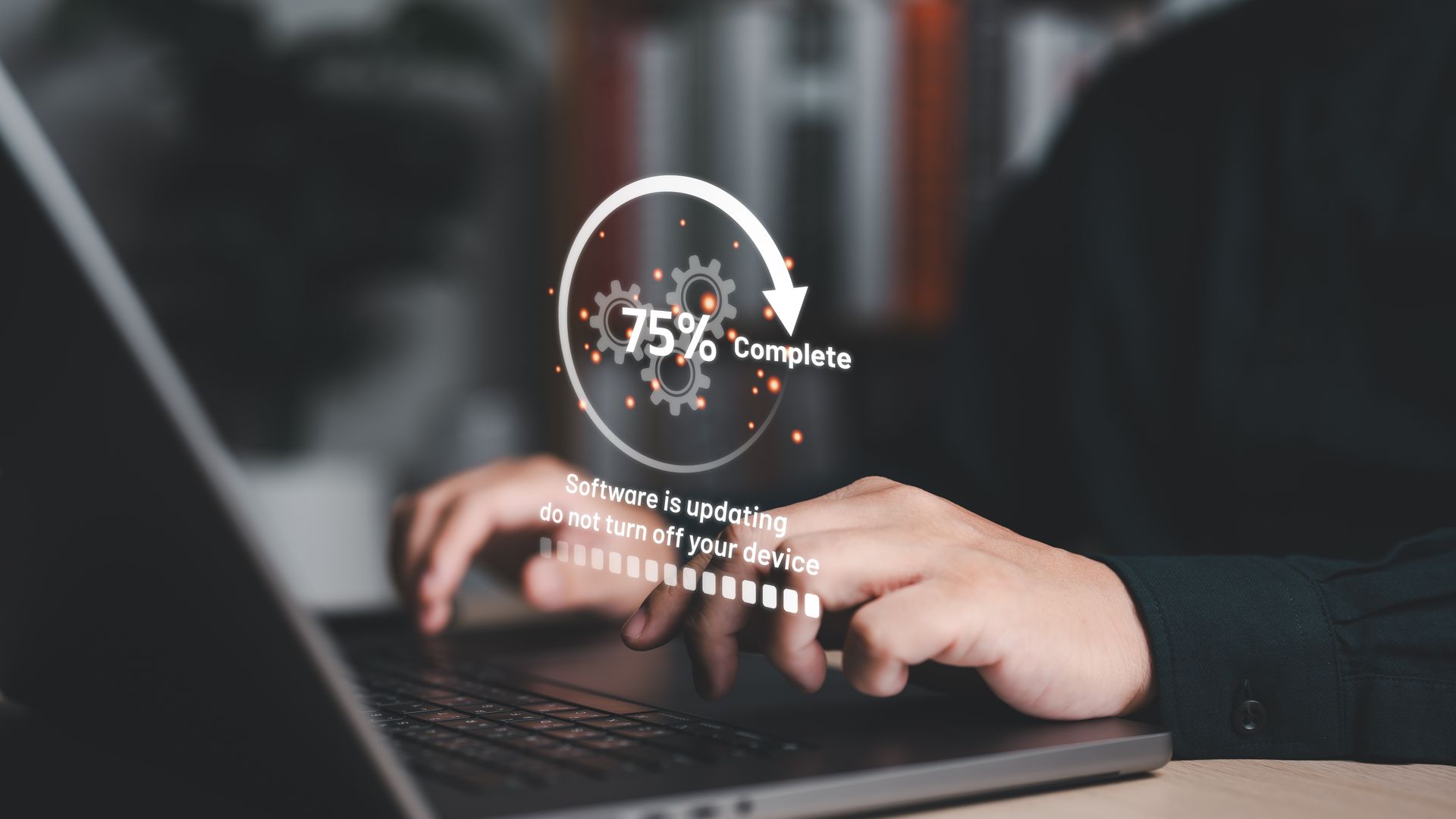 Hands typing on laptop with a circular 75% progress graphic overlay.