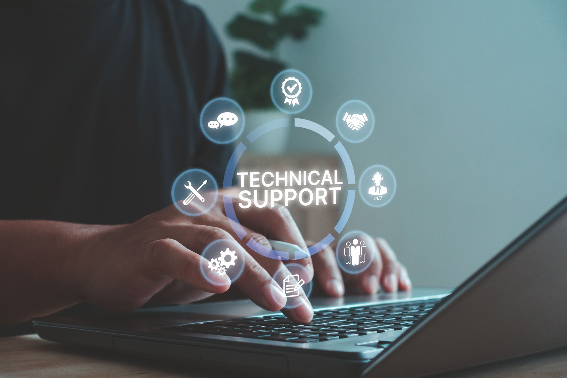 Hands typing on a laptop with a glowing “Technical Support” interface and icons overlayed.