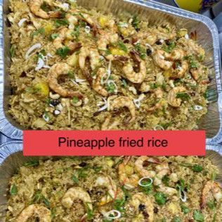 Tray of pineapple fried rice topped with shrimp and green onions, labeled in red text.