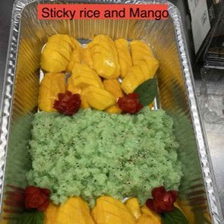 Tray of green sticky rice with sliced mango and red garnish labeled “Sticky rice and Mango”