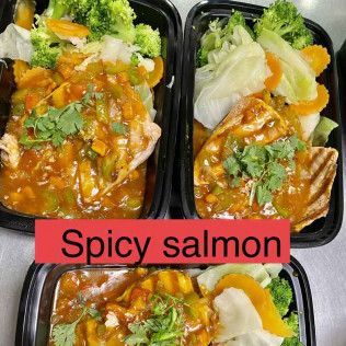 Three meal prep containers with spicy salmon, rice, and broccoli; one labeled “Spicy salmon.”