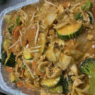 Stir-fried vegetables and mushrooms in a glossy brown sauce on a plate