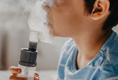 Child using a nebulizer mask for breathing treatment