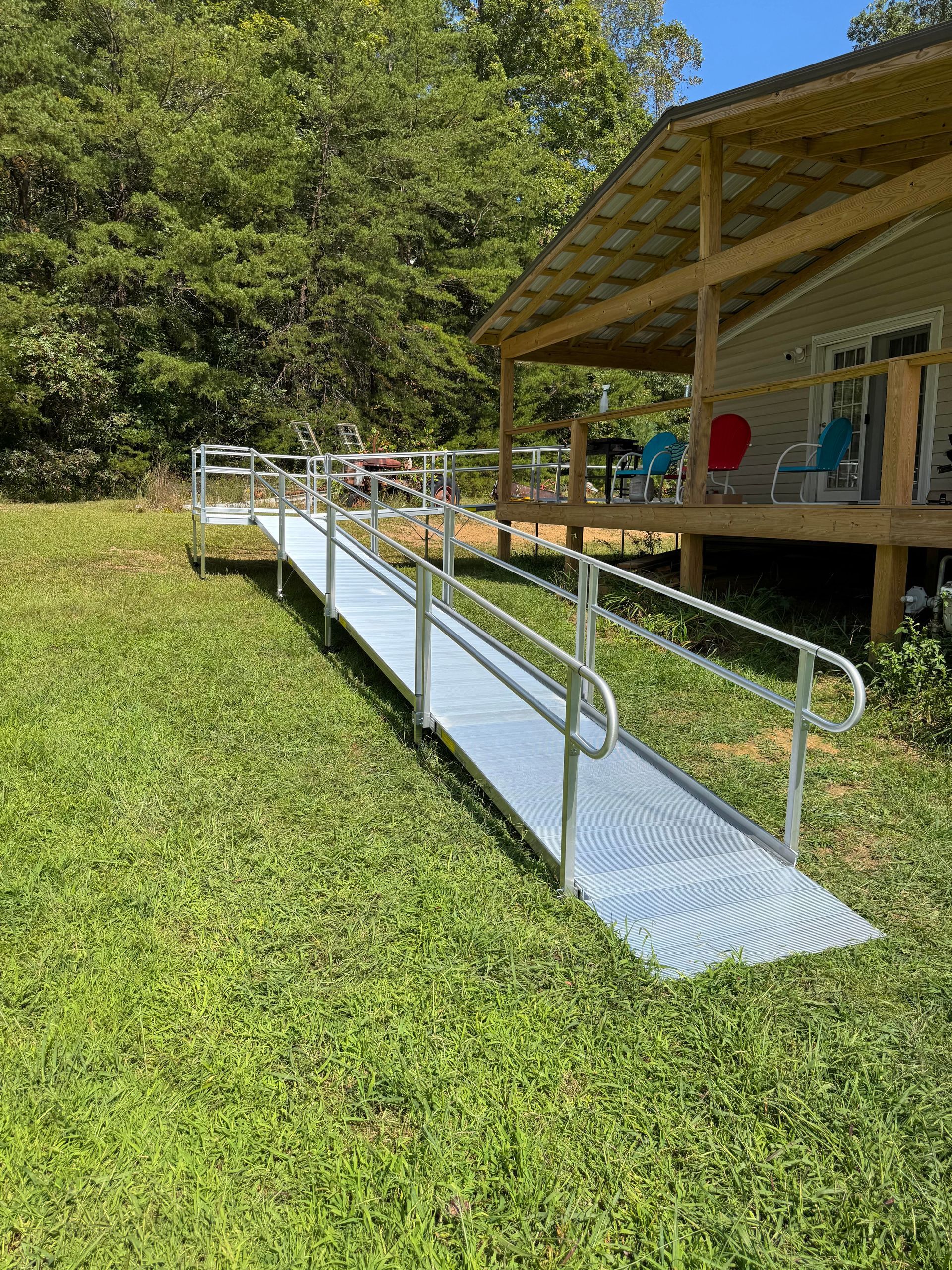 Accessible ramp leading to a building entrance in a grassy outdoor setting