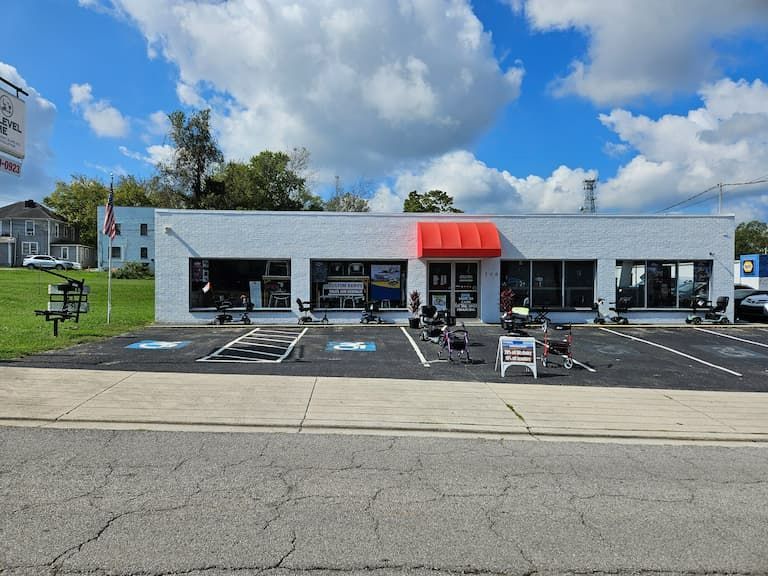 Storefront with red awning, parking spaces, and outdoor equipment