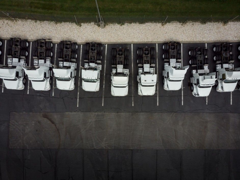 A Row of White Trucks Are Parked in a Parking Lot — JEC Transport in Winnellie, NT