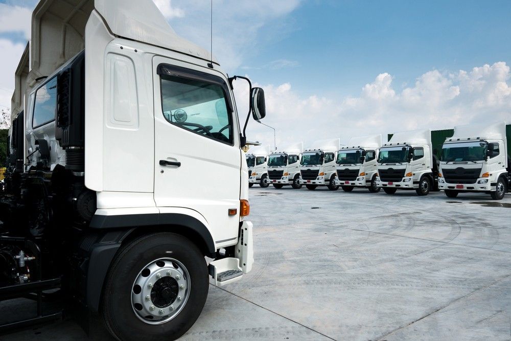 A Row of Trucks Are Parked in a Parking Lot — JEC Transport in Winnellie, NT