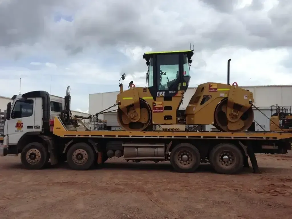 A Large Road Roller is Being Towed by a Tow Truck — JEC Transport in Winnellie, NT