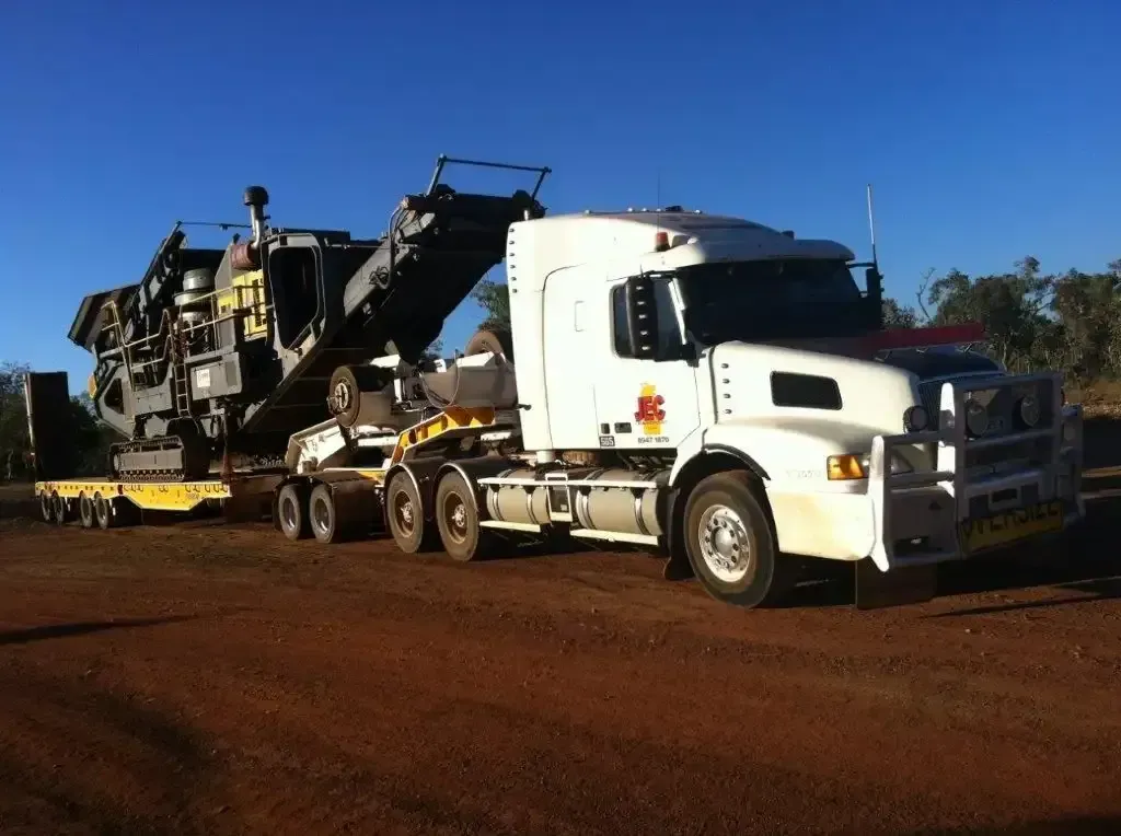 A Large Machine is Being Towed by a Flatbed Truck — JEC Transport in Winnellie, NT