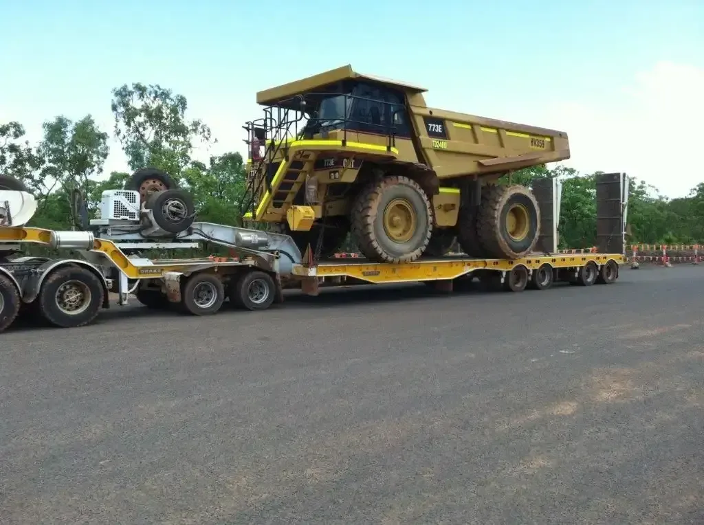 A Yellow Crane is Parked on the Side of a Truck — JEC Transport in Winnellie, NT