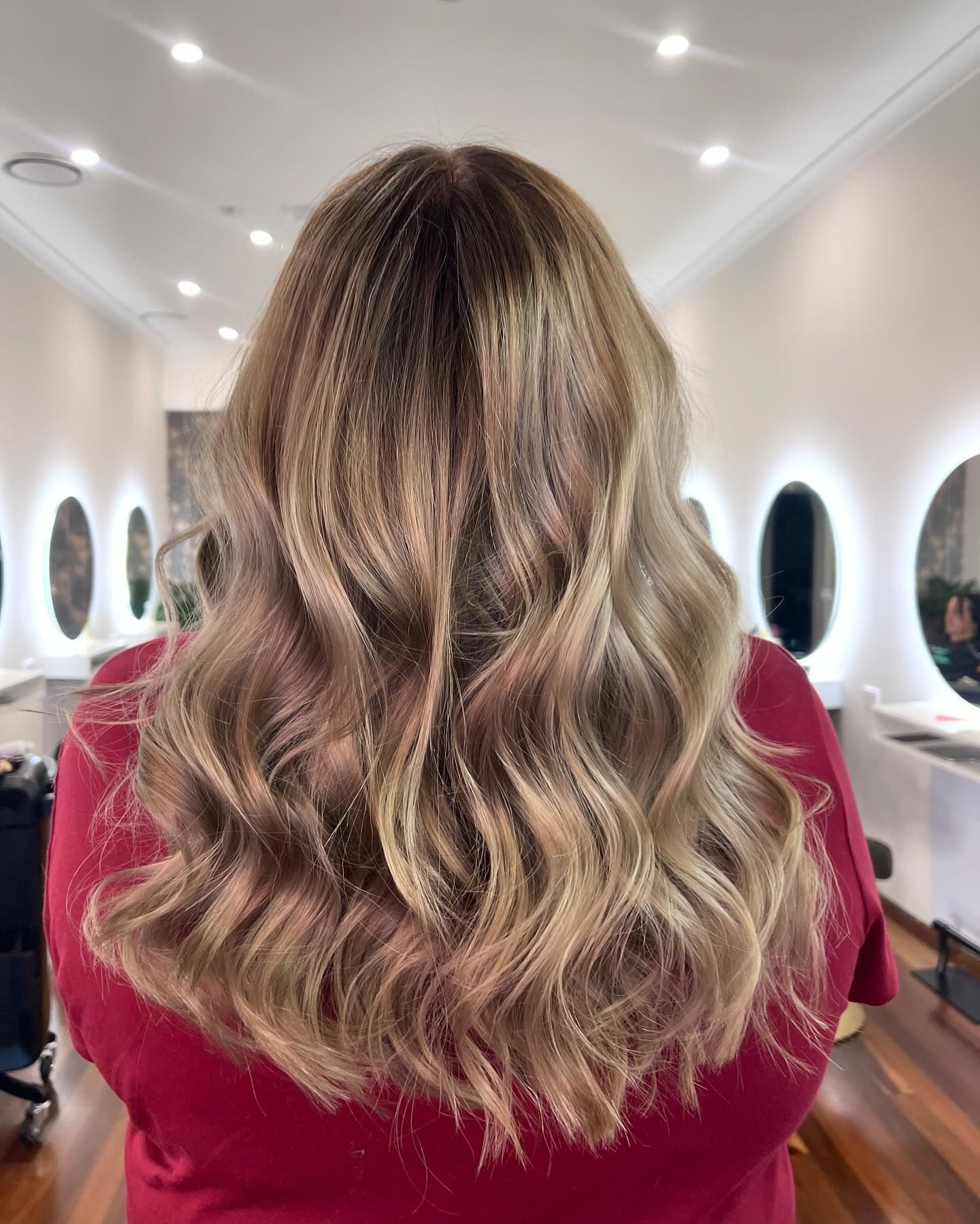 Wavy Blonde-highlighted Hair From Behind in a Salon — Hair Truss & Co In Wallsend, NSW
