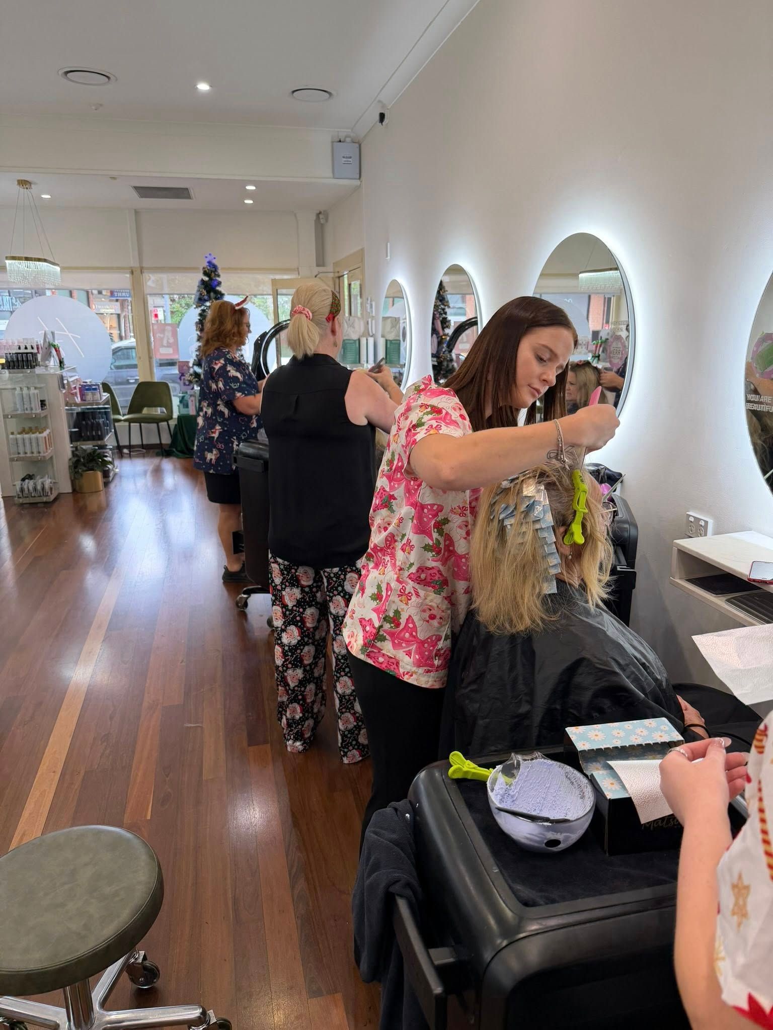 Hair Salon With Stylists Working on Clients in a Bright, Mirrored Room — Hair Truss & Co In Wallsend, NSW