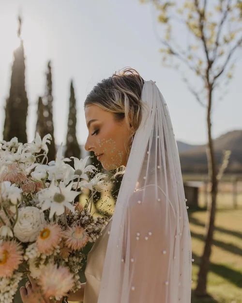 Bride in a White Veil Holding a Bouquet of White and Blush Flowers — Hair Truss & Co In Wallsend, NSW