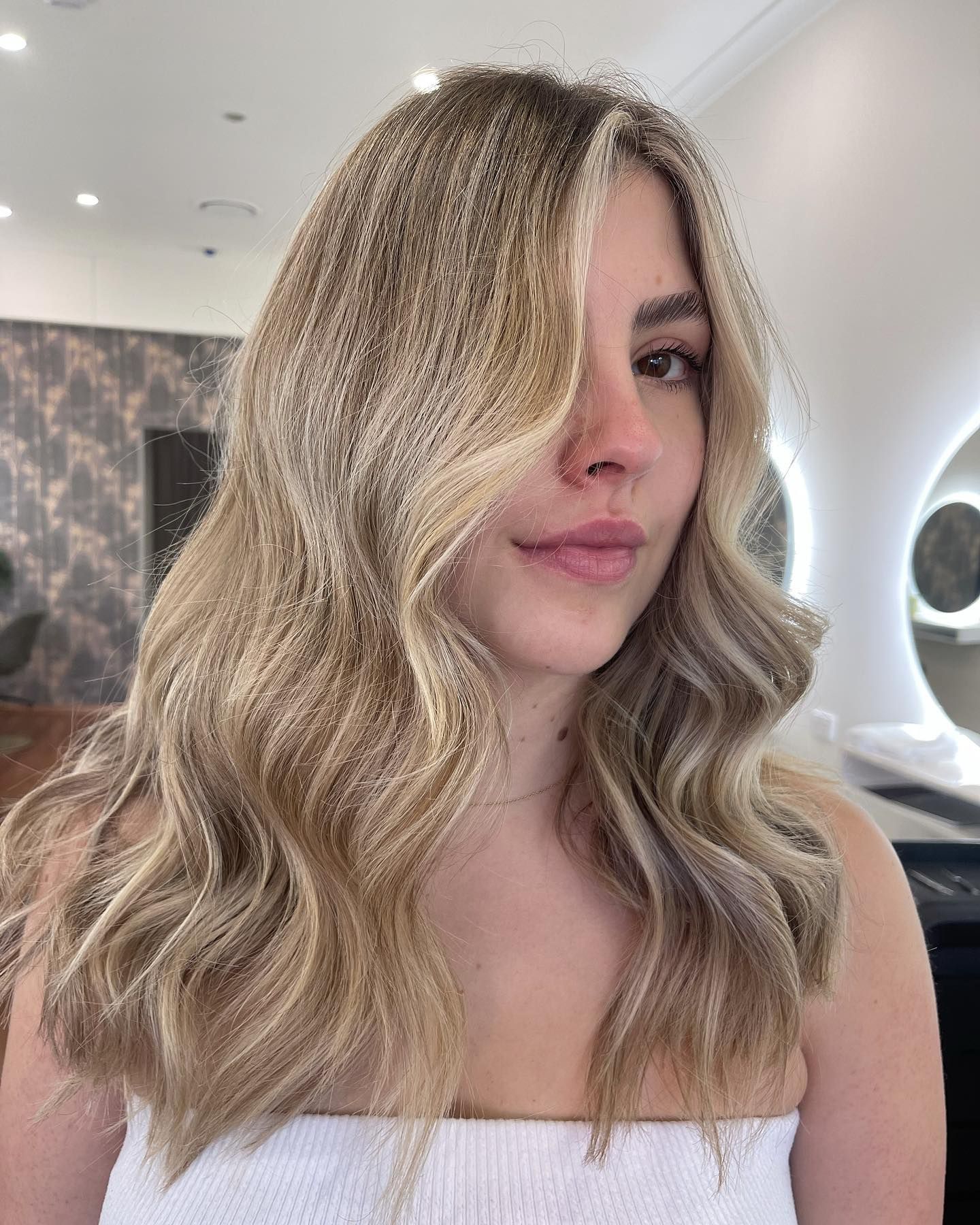 Blonde Wavy-haired Person in a Posing Indoors With a Neutral Expression — Hair Truss & Co In Wallsend, NSW