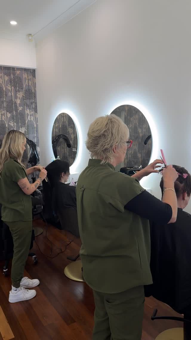 People Viewing Two Circular Wall Artworks in a Gallery, Lit by Bright Halo Lights — Hair Truss & Co In Wallsend, NSW