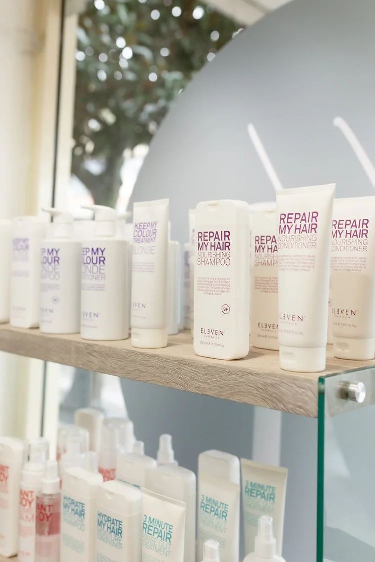 Shelves of White and Pastel Skincare Bottles and Tubes in a Bright Store Display — Hair Truss & Co In Wallsend, NSW