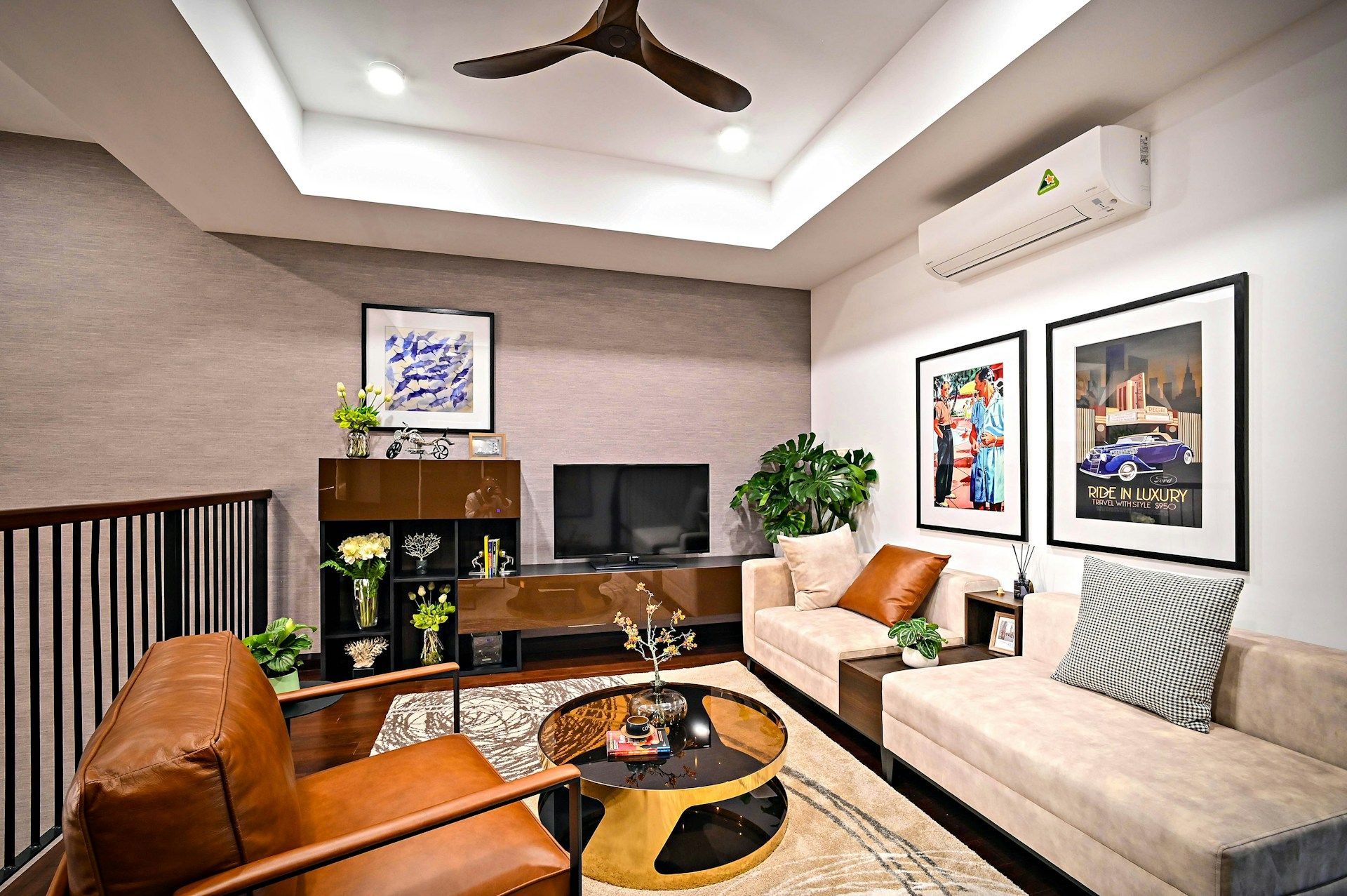Living room with wood trim, rug, sofa, desk, and view into a stairwell.