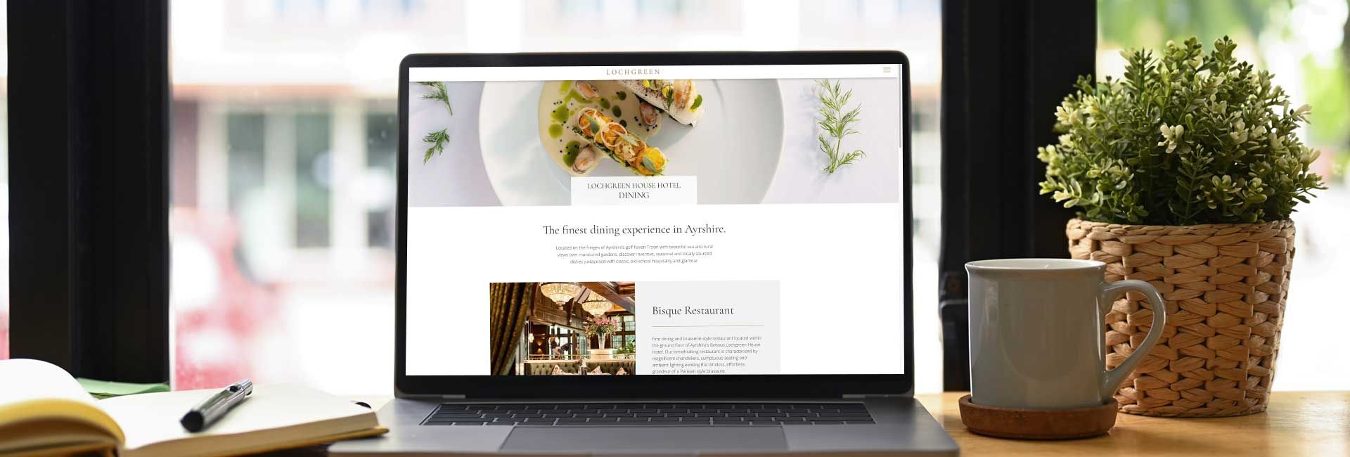 a laptop is open to a page that says Bisque restaurant