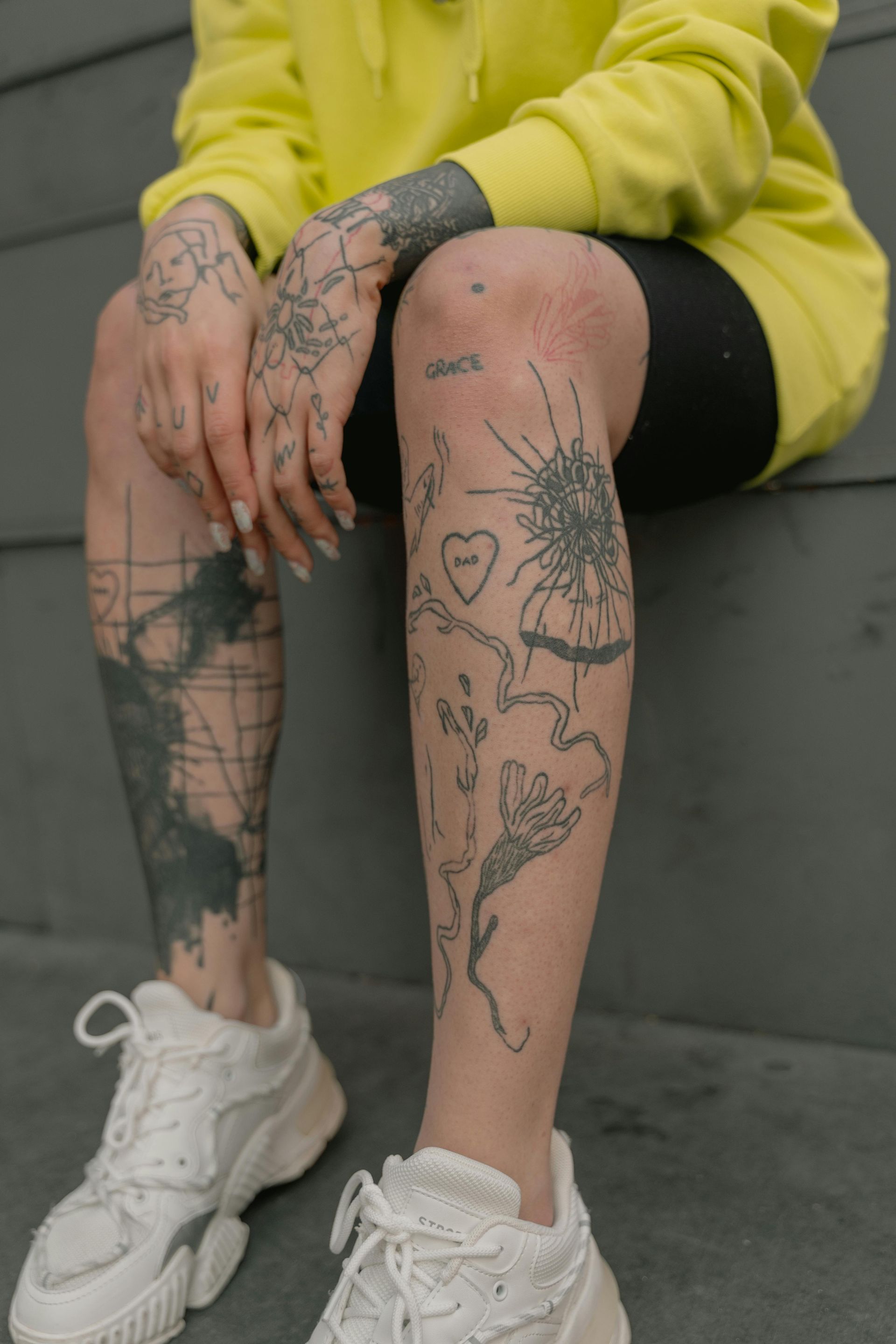 someone is sitting. Knees and hands are the only prevalent feature