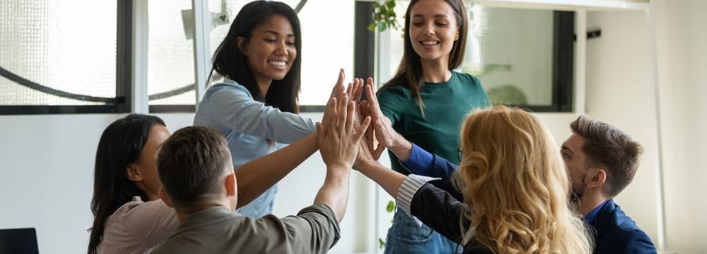 A group of people are giving each other a high five.