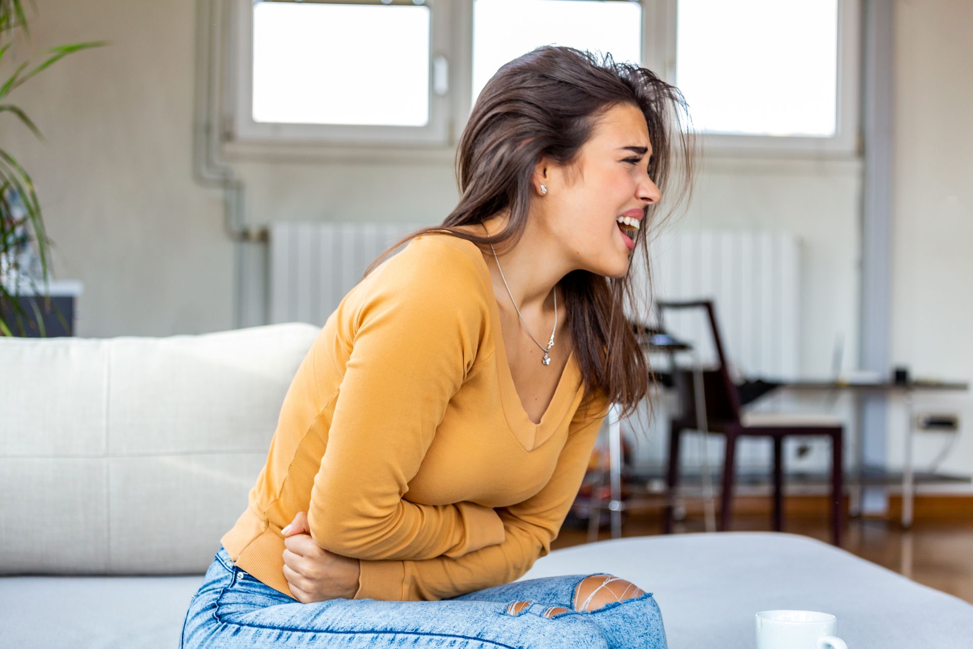 Crying woman due to emotional overwhelm of abdominal pain
