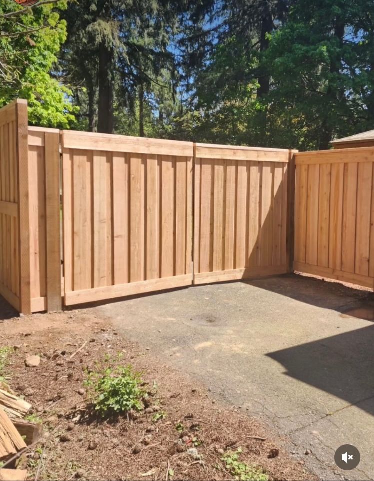 A wooden fence with a gate in the backyard