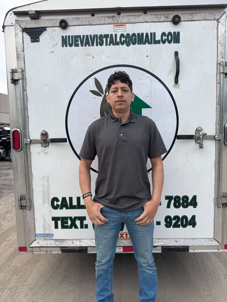 A man standing in front of a trailer that says call text