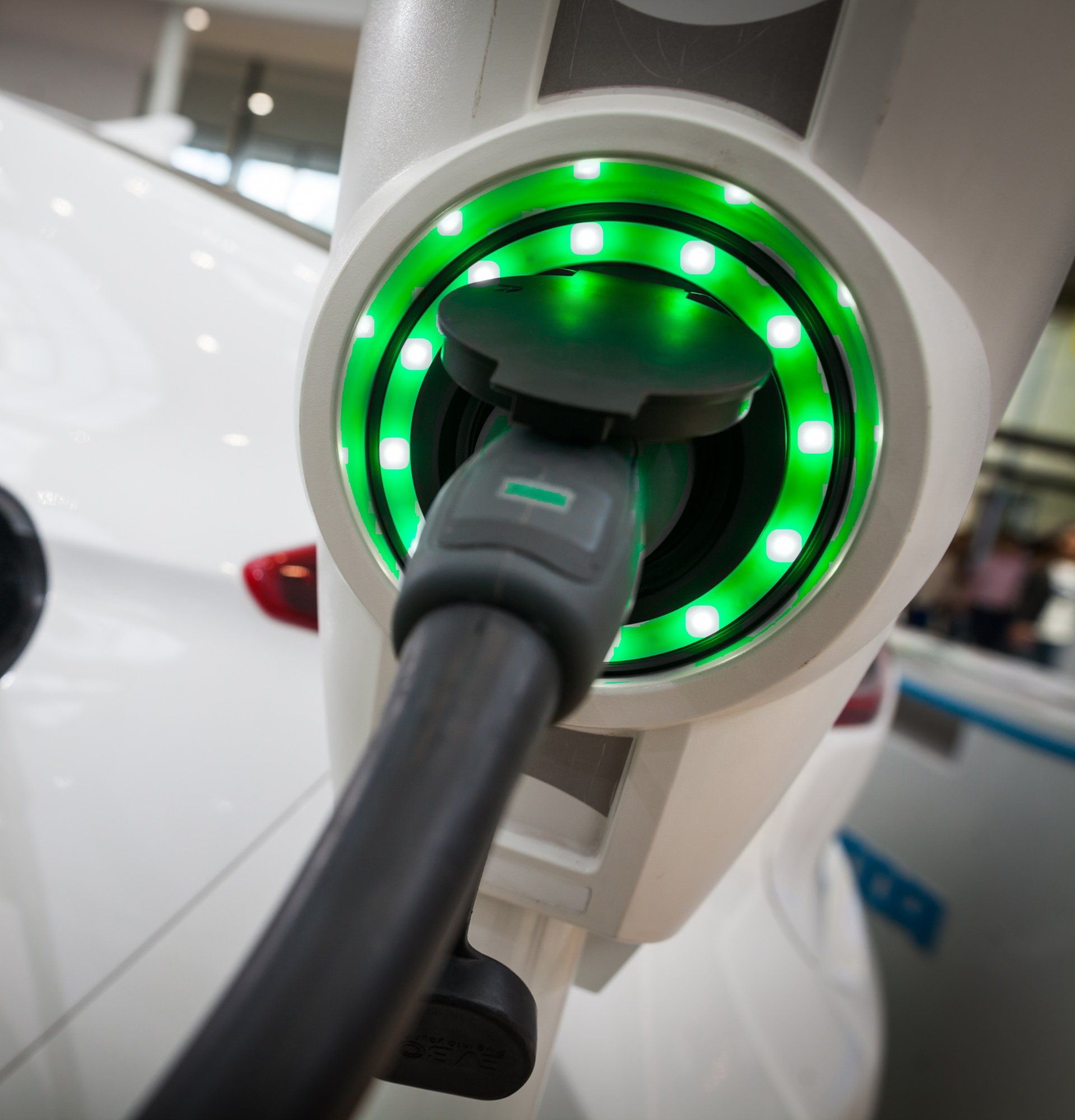 A car is being charged at a charging station