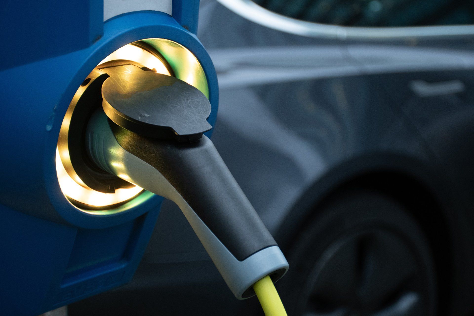 An electric car is being charged at a charging station.