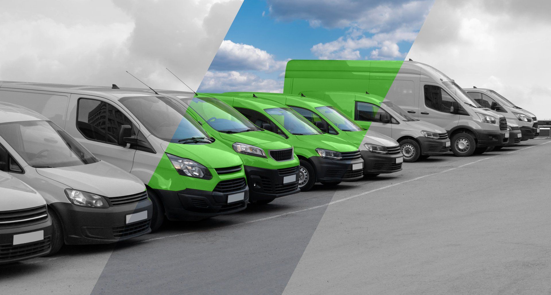 A row of vans are parked in a parking lot.