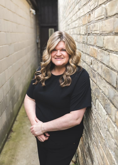 Headshot of Jenn in brick alley