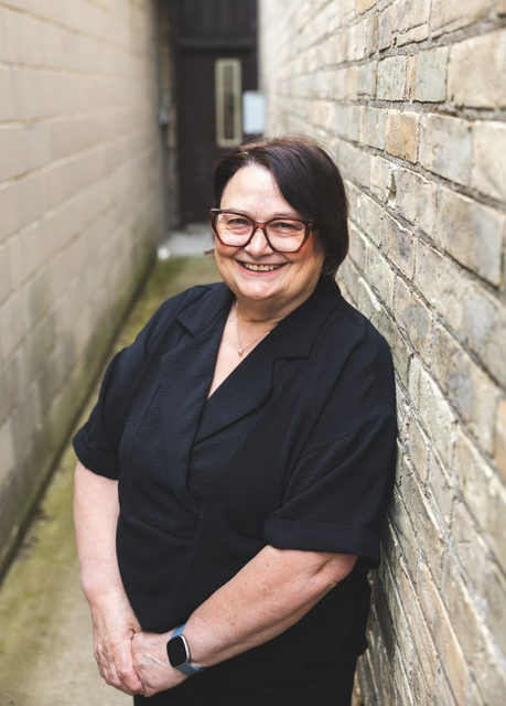 Headshot of Karen in brick alley