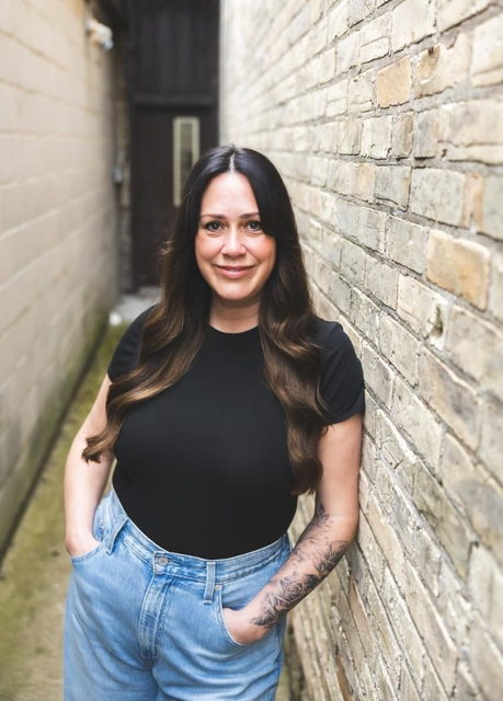 Headshot of Kim in brick alley