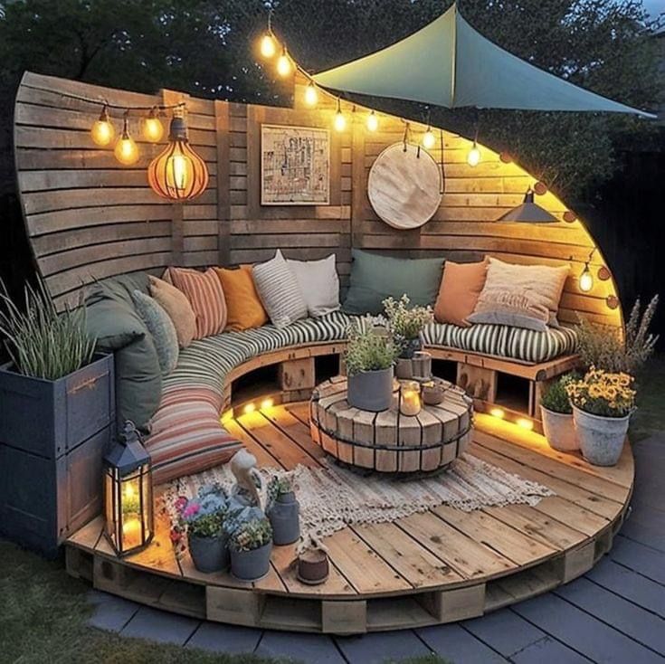 A wooden patio with a couch and a table made out of wooden pallets