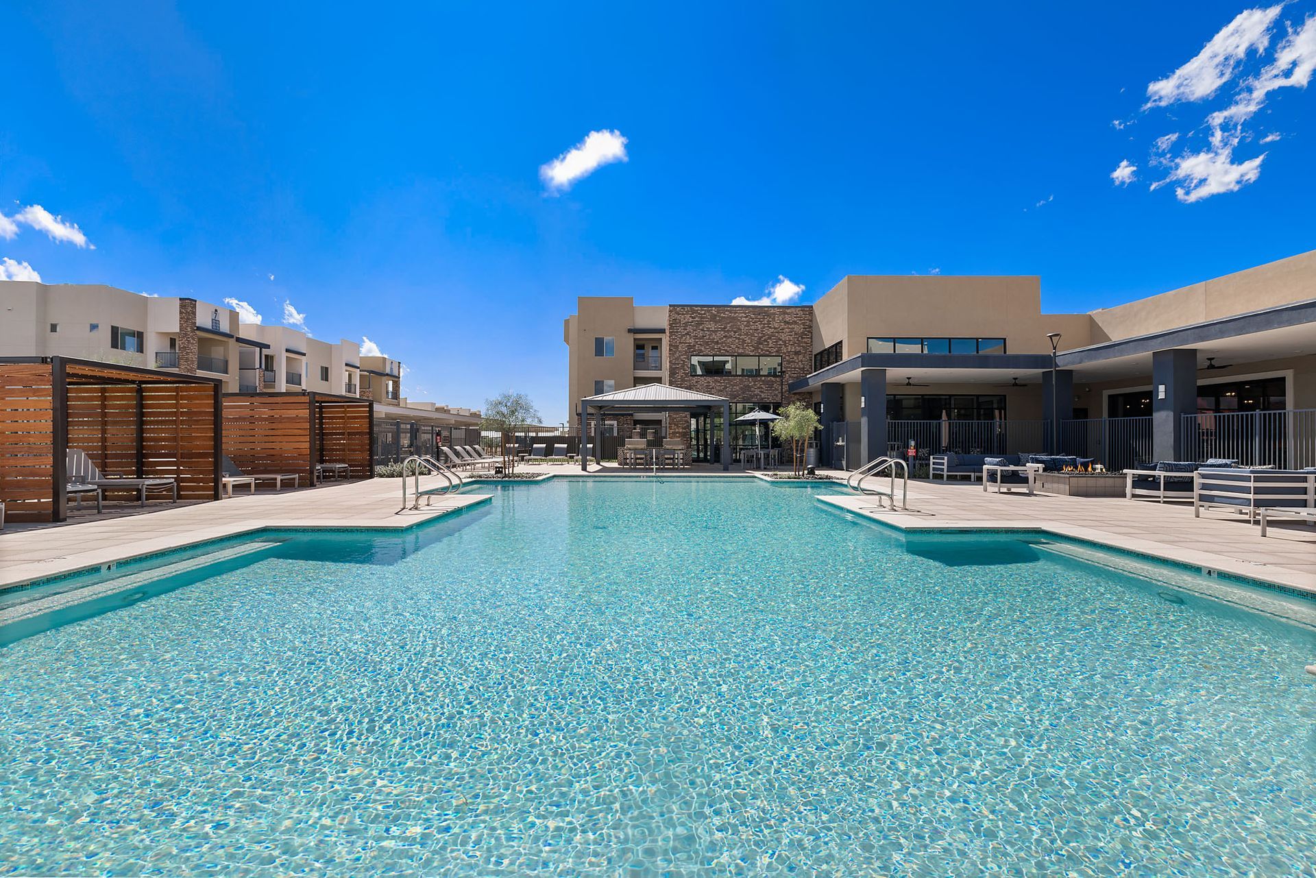 Swimming pool at a modern apartment complex on a sunny day at Marq Bronco Butte, offers brand-new apartments near USAA in North Phoenix, AZ.