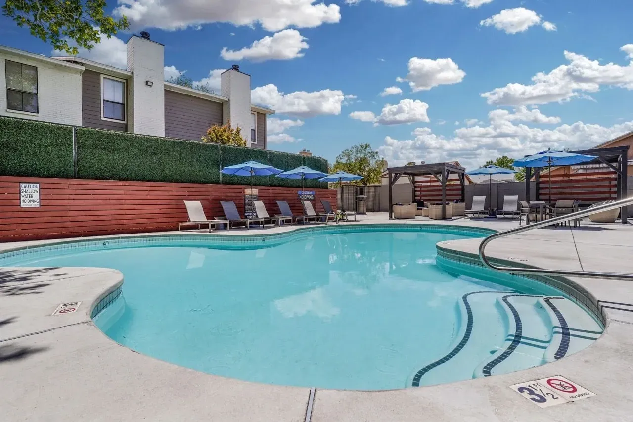 Swimming pool with lounge chairs and umbrellas