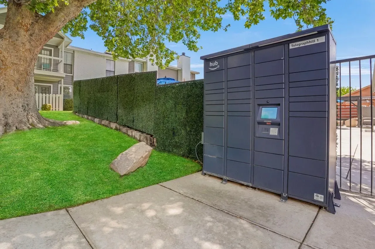 Amazon Hub package locker system with building in background.