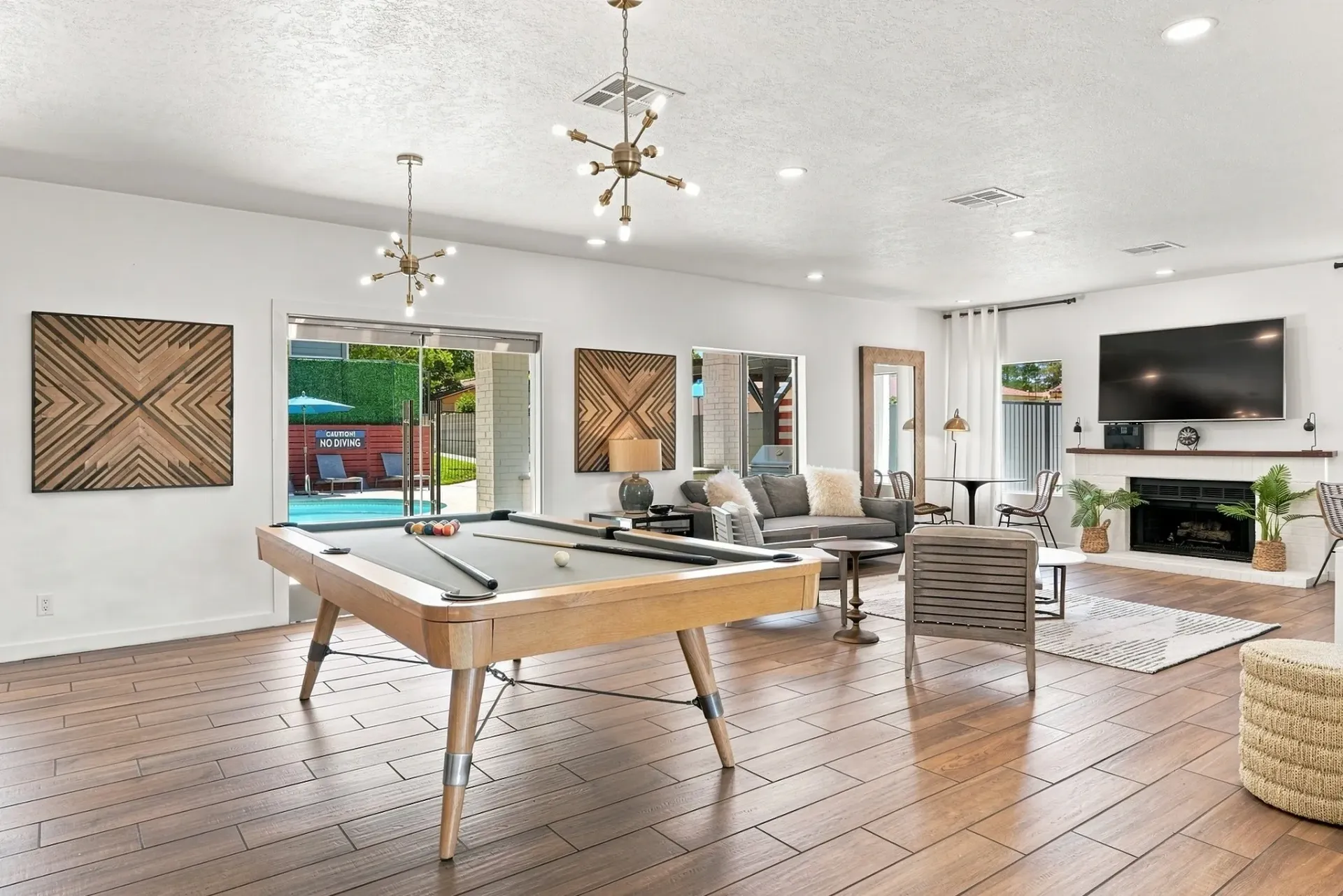 Billiards room with pool table and lounge area with fireplace and TV
