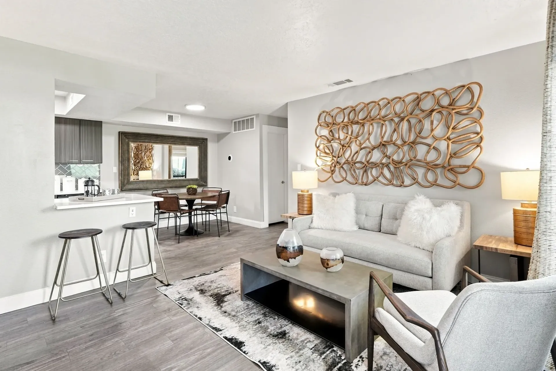 Modern living room and dining area with contemporary furniture and decor.